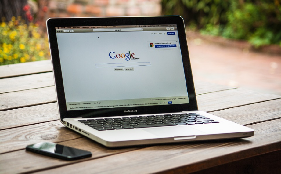 a laptop on the table showing google icon