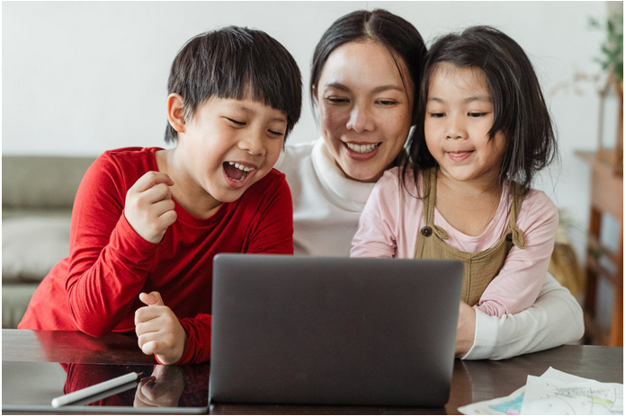 mother and children watching video on PC
